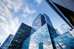 View from ground-level, looking up at a series of tall buildings in a city