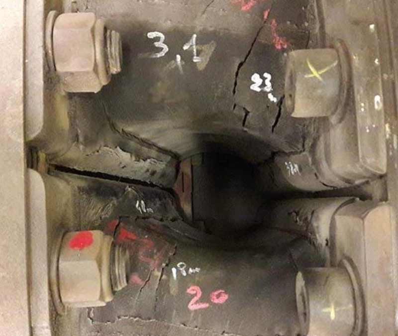 Photo of coupling with cracks clearly marked.