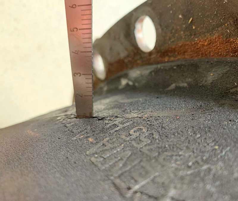Photo of ruler measuring depth of a crack in a coupling.