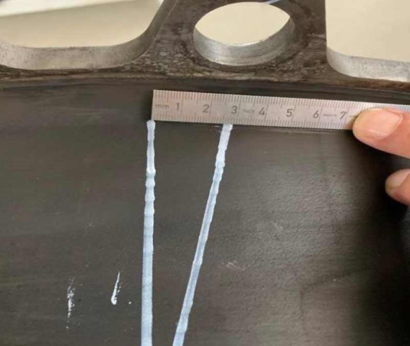 Photo of ruler measuring two points on a coupling.