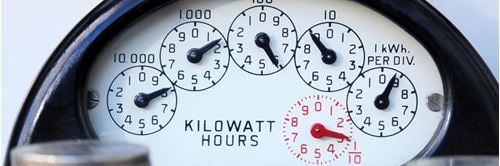 Photo of electric meter showing dials at different points measuring kilowatt hours.
