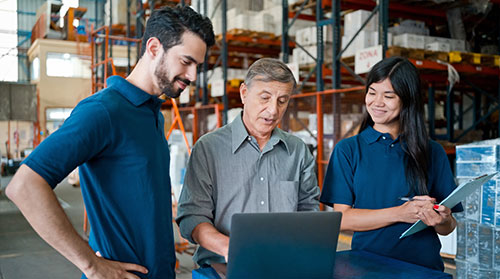 3 people in front of a laptop